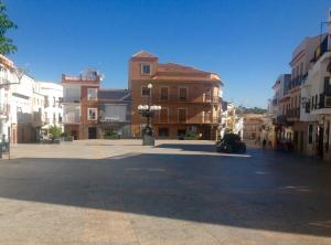 an empty street in a city with buildings at A.T. La Plaza in Calamonte