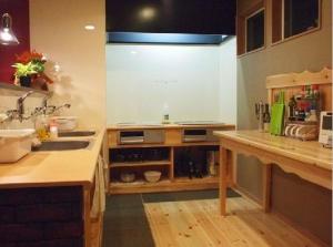 a kitchen with a sink and a counter top at Aso Base Backpackers in Aso