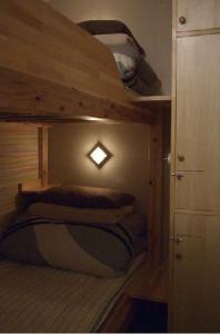 a bedroom with a bunk bed with a light on it at Aso Base Backpackers in Aso