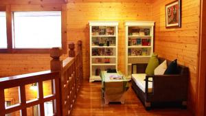 a living room with a couch and chairs in a room at Luka Garden BnB in Ren'ai