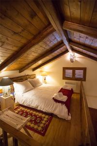 a bedroom with a large bed in an attic at Monte Bianco Villas in Arachova