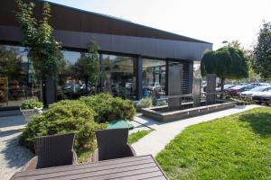 a building with chairs in front of a building at Hotel Jelena Brčko in Brčko
