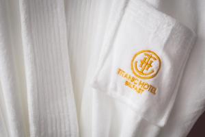 a white shirt with a orange logo on it at Titanic Hotel Belfast in Belfast