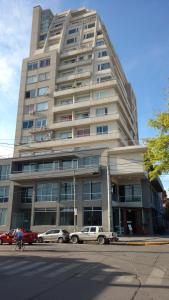 a large building with cars parked in front of it at Tu Lugar en Salta in Salta