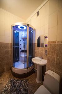 a bathroom with a shower and a toilet and a sink at Hostel City Life in Tyumen