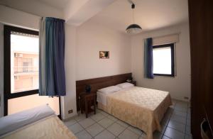 Letto o letti in una camera di Hotel Nettuno