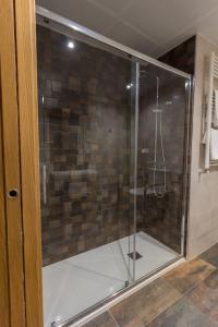 a shower with a glass door in a bathroom at Hotel Novo Cándido in Ourense