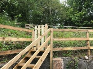 a wooden gate next to a fence at Hobbit Hollow in Ballymore Eustace