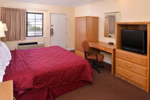 A bed or beds in a room at Executive Inn