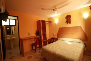 Postel nebo postele na pokoji v ubytování Hotel Puuc