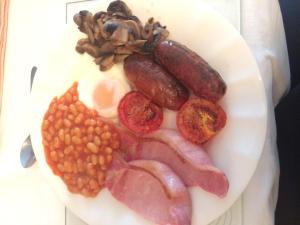 a plate of food with meats beans and nuts at The Elms in East Harling