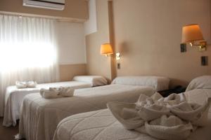 Una cama o camas en una habitación de Hotel Bertaina