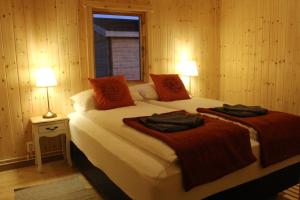 a bedroom with a bed with two robes on it at Guesthouse Didi in Flagbjarnarholt