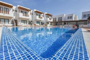 a large swimming pool in front of a building at Casa Zen in Puerto Calero