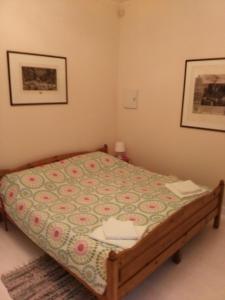 a bedroom with a bed with a comforter on it at Dora Apartment Užupis in Vilnius