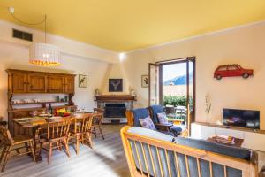 a living room with a table and a dining room at Bellagio Lake View Villa in Oliveto Lario