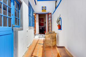 a hallway with a blue door and a bench at Backup-Powered Art Deco Cottage in De Waterkant in Cape Town
