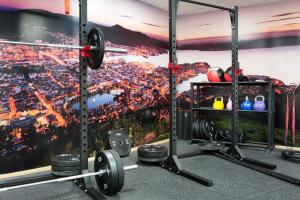 a gym with a wall mural of a city at Comfort Hotel Bergen Airport in Bergen
