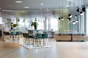 a restaurant with chairs and tables in a room at Comfort Hotel Bergen Airport in Bergen