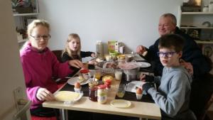 a group of people sitting at a table eating food at B&B de Rivierduin in Hattem