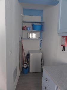 a small kitchen with a refrigerator and a microwave at Casa Pelourinho in Silves