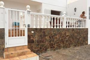 a woman standing on the balcony of a house at Casa Frasca in Teguise