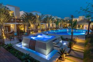 a resort with a swimming pool at night at Pousada Arte da Natureza in Bonito