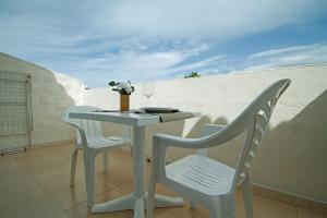 a white table and chairs on a balcony at Paradero II in Playa de las Americas