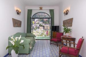 a living room with a couch and a window at Hotel Poseidon in Positano