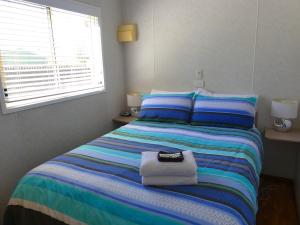 
A bed or beds in a room at Pelican Waters Holiday Park
