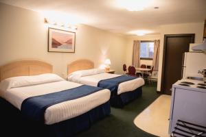 A bed or beds in a room at Radium Park Lodge