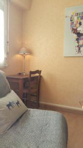 a bedroom with a desk and a bed and a table at T2 Bis Luchon in Luchon