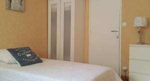 a bedroom with a bed with a pillow on it at T2 Bis Luchon in Luchon