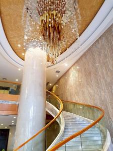 a chandelier in a shopping mall with a escalator at Swiss-Belhotel Blulane in Manila