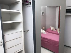a small bedroom with a bed and a closet at Monoambiente cómodo in Buenos Aires