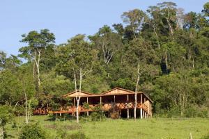 a wooden house in the middle of a field at Aires del Monte in El Soberbio