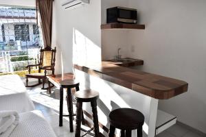 a kitchen with a counter and stools in a room at Hotel Mary Carmen in Cozumel