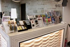 a shelf with books on top of a fireplace at Grand Park Hotel Panex Tokyo in Tokyo