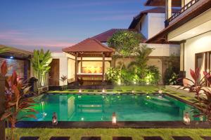a swimming pool in the backyard of a house at Concetta Villa Seminyak Beachside in Seminyak