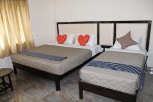 Postel nebo postele na pokoji v ubytování Hotel Jaidharshini Palace