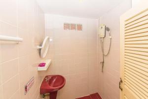 a bathroom with a red toilet and a shower at Aree's House in Hua Hin