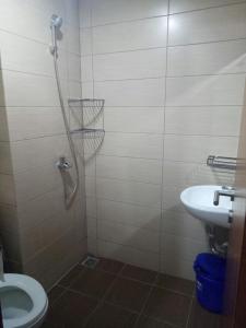 a bathroom with a shower with a toilet and a sink at Wjy Apartment Margonda Residence 5 in Depok