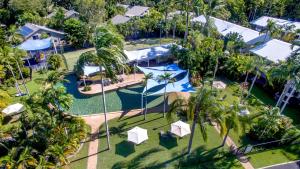 an aerial view of a resort with a pool and palm trees at Nimrod Resort Apartments in Port Douglas