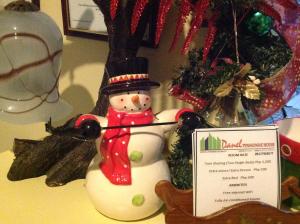 a snowman figurine next to a sign on a table at Danel Pensionne House in Tacloban
