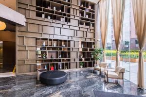 a lobby with a large wall of books at Green Court Residence Jinqiao Diamond Shanghai in Shanghai