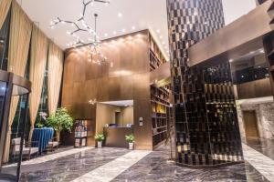 a library with bookshelves and a tall building at Green Court Residence Jinqiao Diamond Shanghai in Shanghai