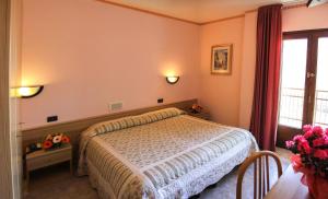 Postel nebo postele na pokoji v ubytování Hotel Les Saisons
