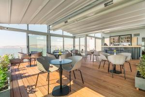 a restaurant with a view of the water at Athens Cypria Hotel in Athens