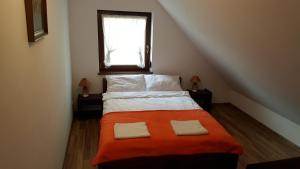 a bedroom with a bed with two pillows on it at Apartamenty Boszkowo in Boszkowo