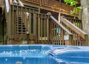 a swimming pool with wooden stairs in the background at Mountain Music #19 in Sevierville